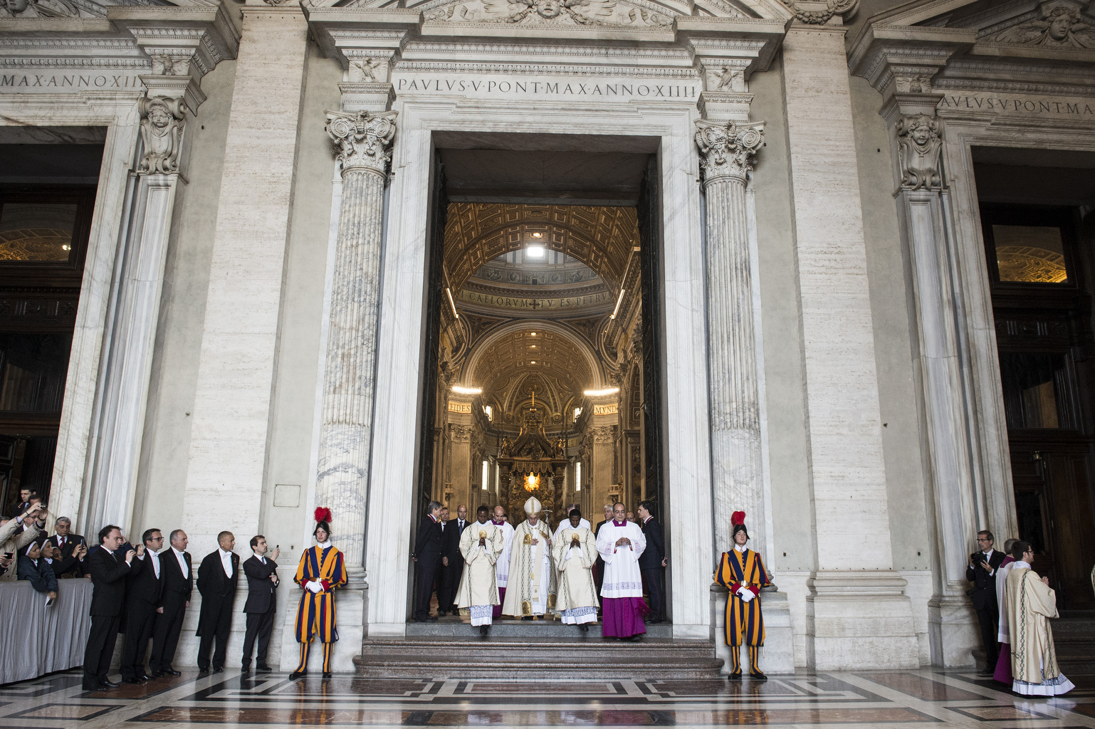 Pope Francis processes through main door of St. Peter's Basilica during first Vespers of Divine Mercy Sunday