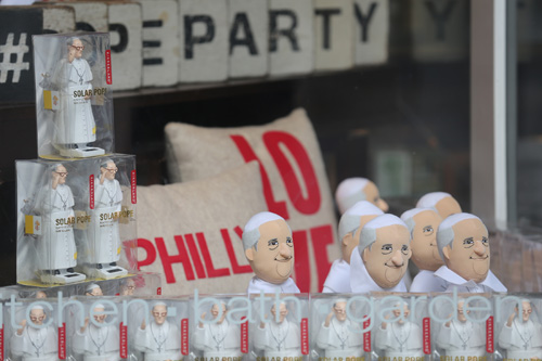 Pope Francis figurines are seen in window display at store along street in Philadelphia