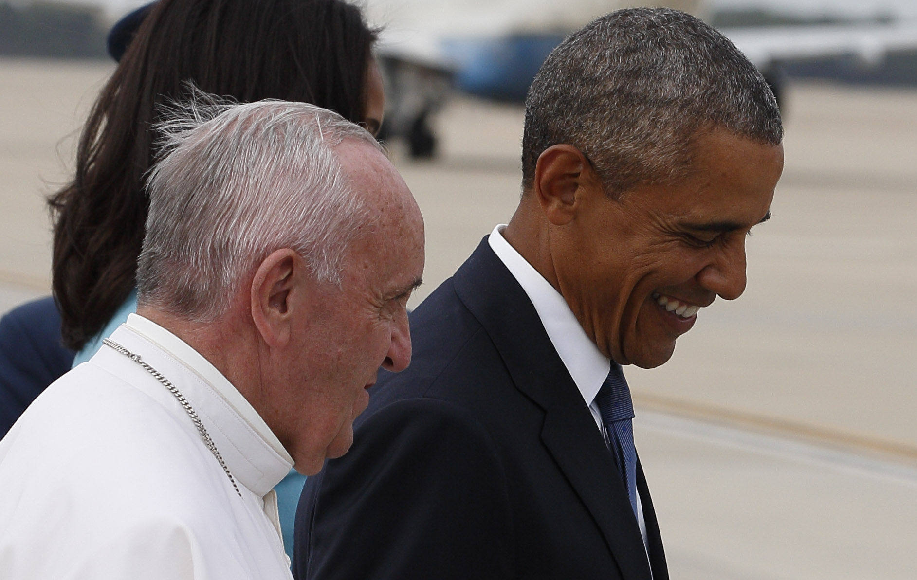 Pope Francis walks with U.S. President Barack Obama on airfield at Joint Base Andrews