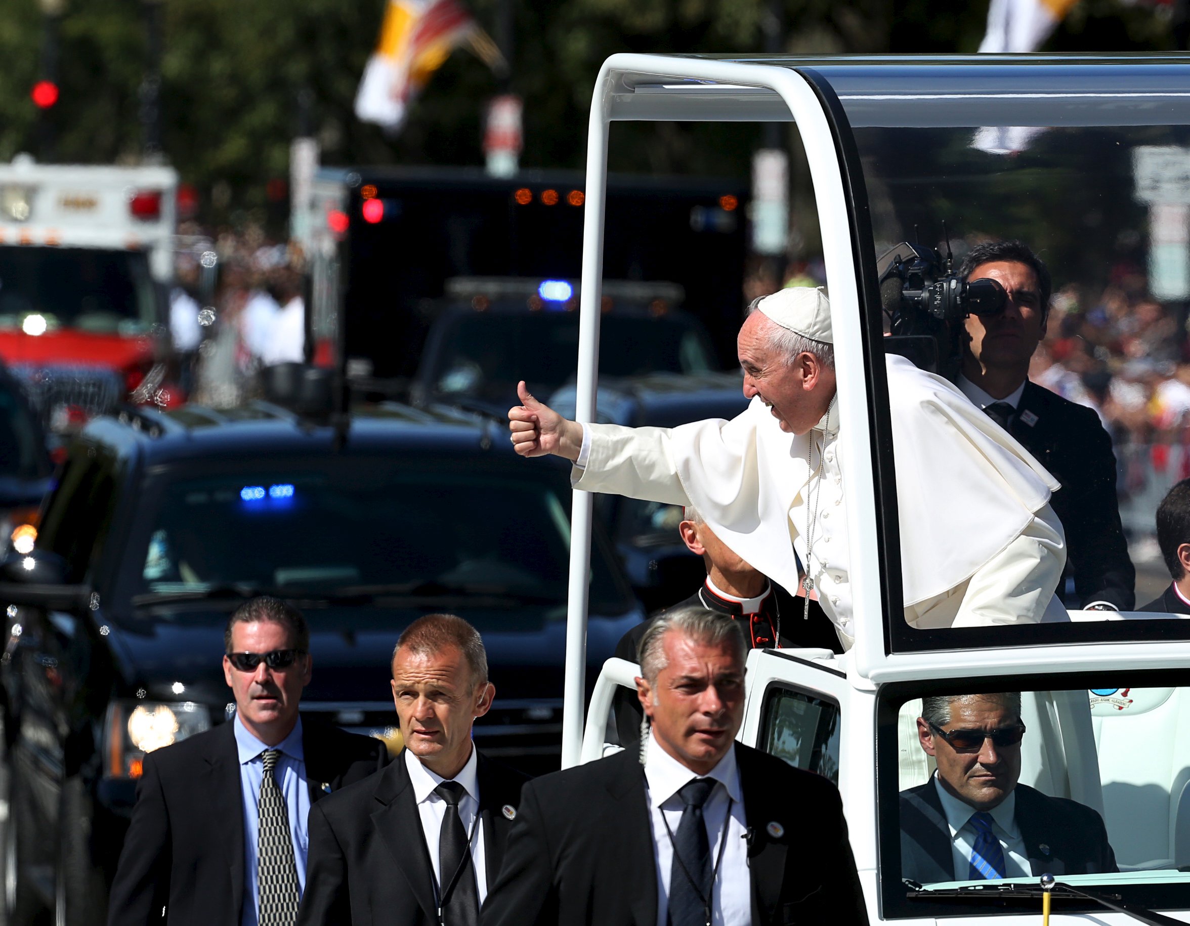 Pope Francis gives thumbs as he rides down Constitution Avenue in Washington