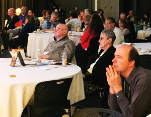 The crowd participating in the New Evangelization Summit April 16 is riveted by Sherry Weddell's presentation on parish renewal. 