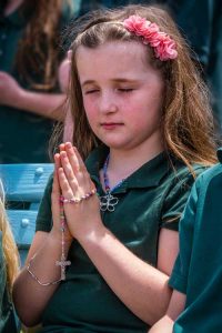 Second grader Breanne Eldred, 8, from All Saints Schoo pray at the Marian Shrine at St. Joseph Church in Endicott Thursday reciting the rosary. -Sun photos | Chuck Haupt