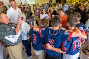 Parishioners greet Maine-Endwell Little League World Champion team members, during a reception held in their honor after Mass at Holy Family Church.