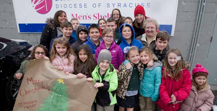 Young visitors from Holy Family grace men’s shelter