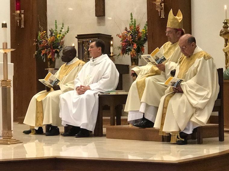 priests on altar with bishop