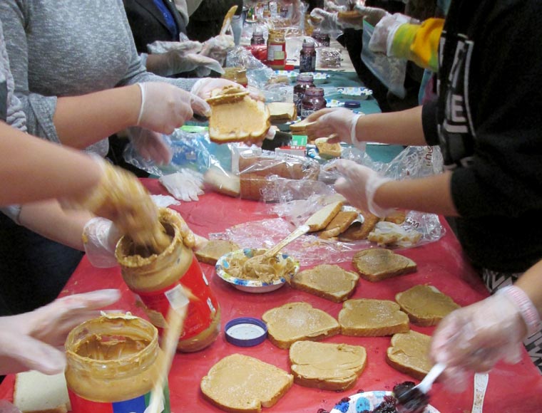 SU Catholic Center’s volunteers hit PBJ ‘assembly line’
