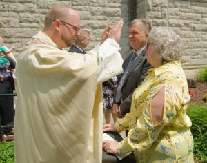 Father Brooks blesses his parents, Randy and Pattee Brooks.