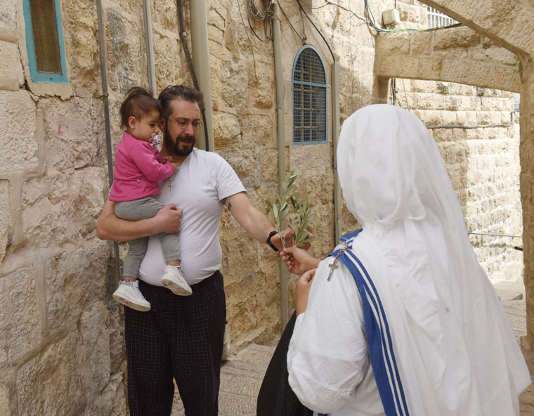 Surgical masks, social distancing: Palm Sunday in Jerusalem’s Old City