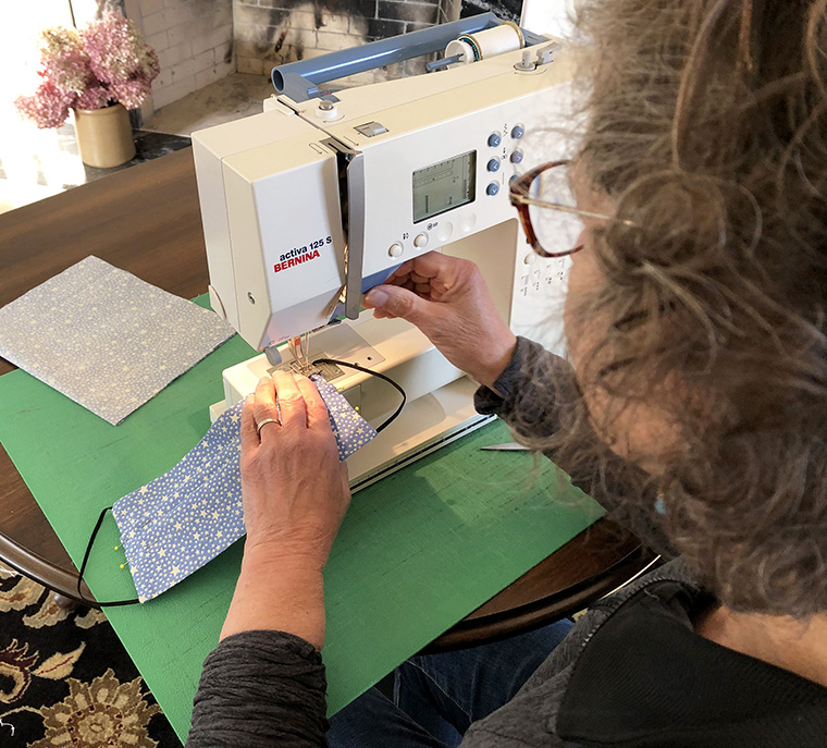 Ann Marie Stone sews