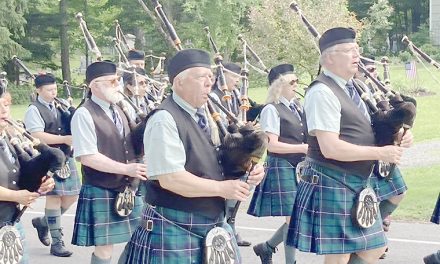 Msgr. Elmer pipes with the band