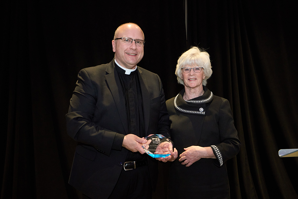 A9209119 Fr Manno accepts award