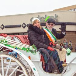 Utica St. Patrick’s Parade Grand Marshal John Sullivan rides in a horse-drawn carriage with his wife, Deborah. (Photo courtesy Thomas Loughlin Jr.)