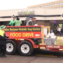 An Adorino Construction crew collects food for the Mother Marianne Westside Soup Kitchen at Utica’s St. Patrick’s Parade. (Photo courtesy Tom Loughlin Jr.)
