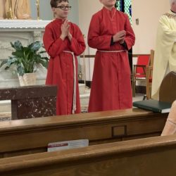 Father Daniel Caughey recognizes Logan and Jason during the Altar Server celebration at St. Malachy’s Church in Sherburne. 
